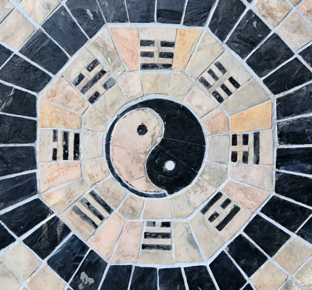 yin yang symbol stone background scaled 1